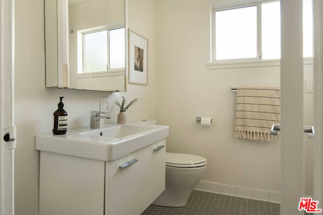 6006 Babbitt Avenue Encino, CA 91316 - Photo 21 of 32 a bathroom with a toilet sink and mirror