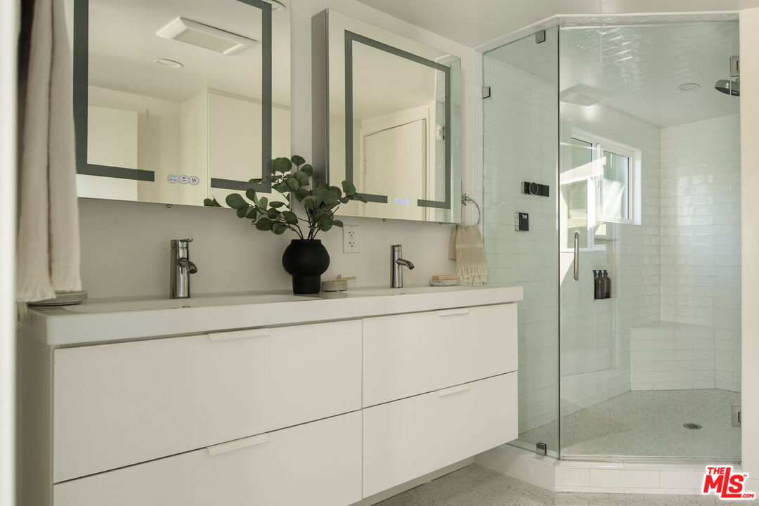 6006 Babbitt Avenue Encino, CA 91316 - Photo 25 of 32 a bathroom with a shower sink and mirror