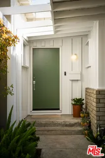 a living room with furniture a clock and a large window