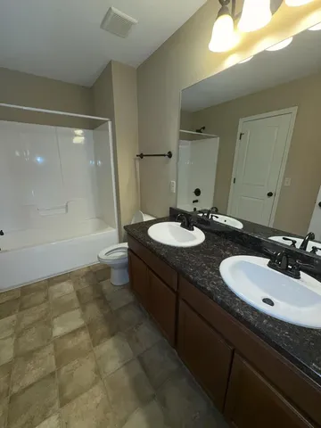 a bathroom with a sink double vanity and a mirror