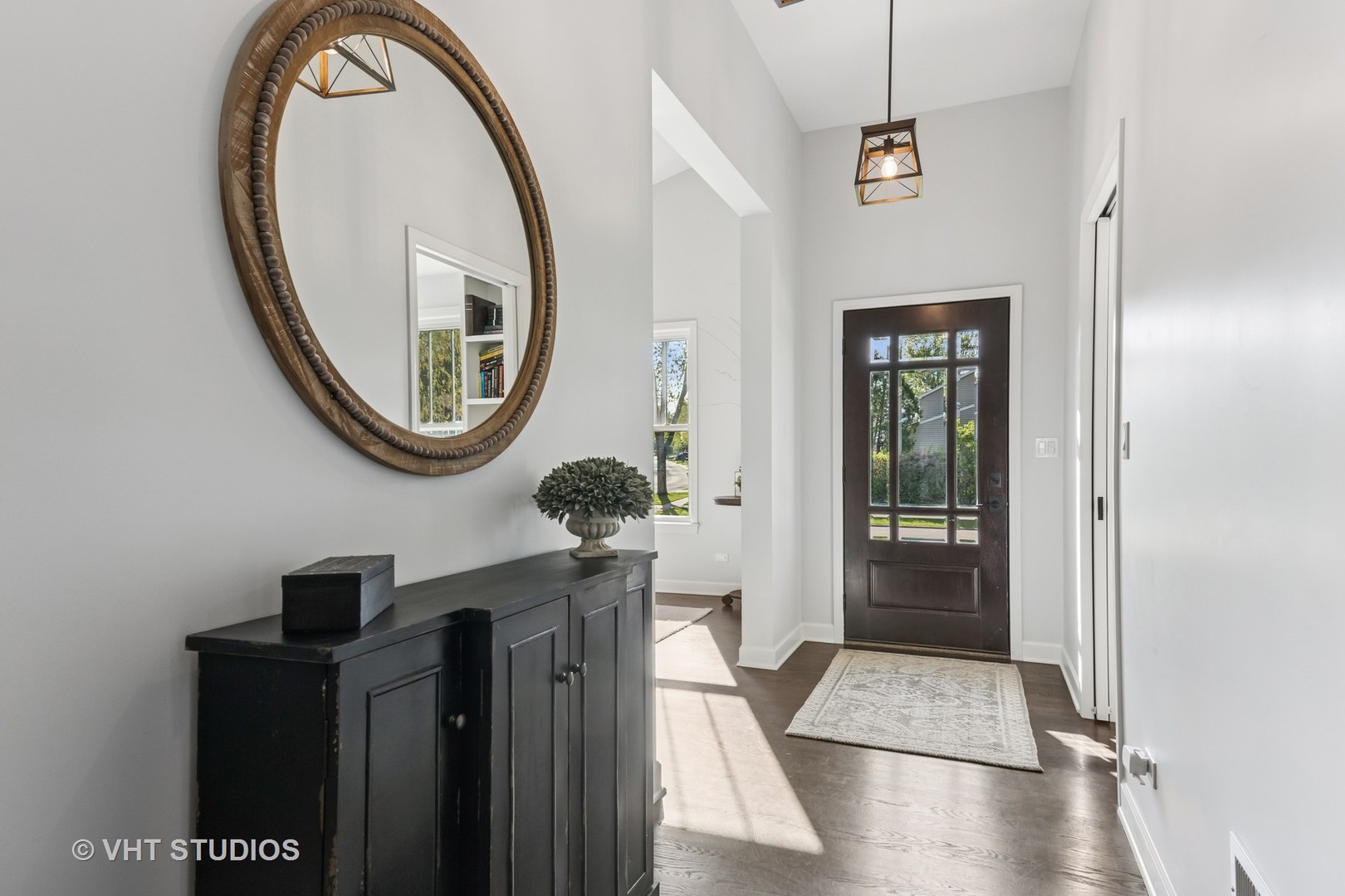 389 Weidner Road Buffalo Grove, IL 60089 - Photo 2 of 25 a view of a hallway with entryway wooden floor and a chandelier