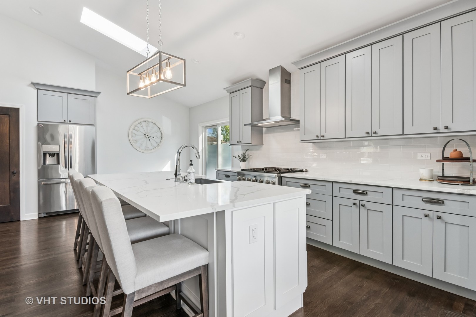 389 Weidner Road Buffalo Grove, IL 60089 - Photo 6 of 25 a kitchen with a dining table chairs cabinets and stainless steel appliances