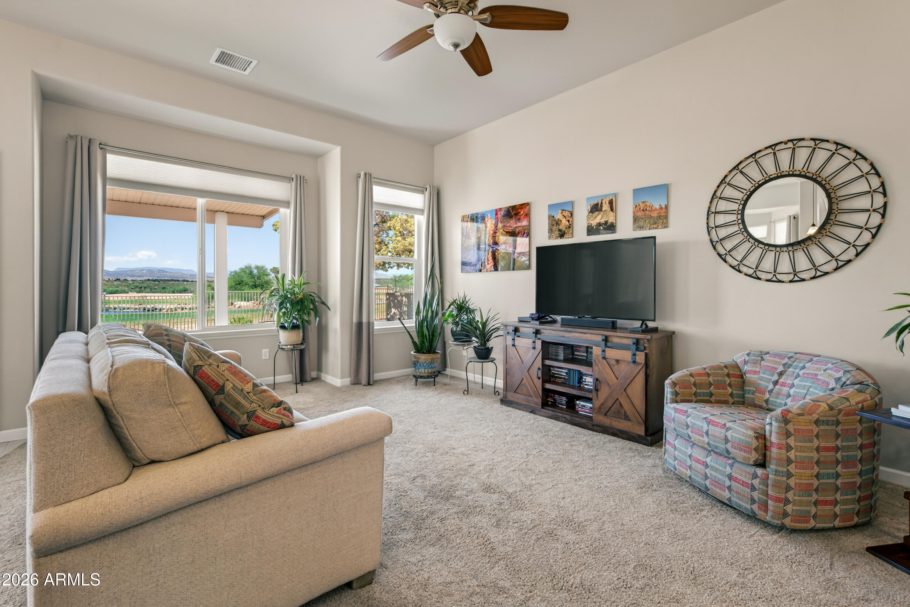 718 South Wandering River Road Cornville, AZ 86325 - Photo 8 of 41 a living room with furniture and a flat screen tv