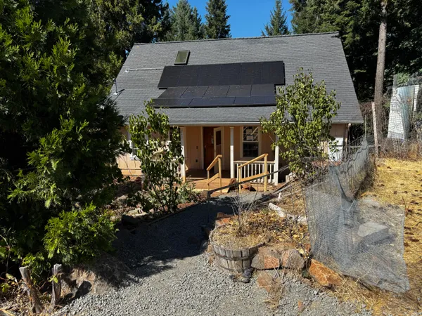 a view of a house with a yard and sitting area