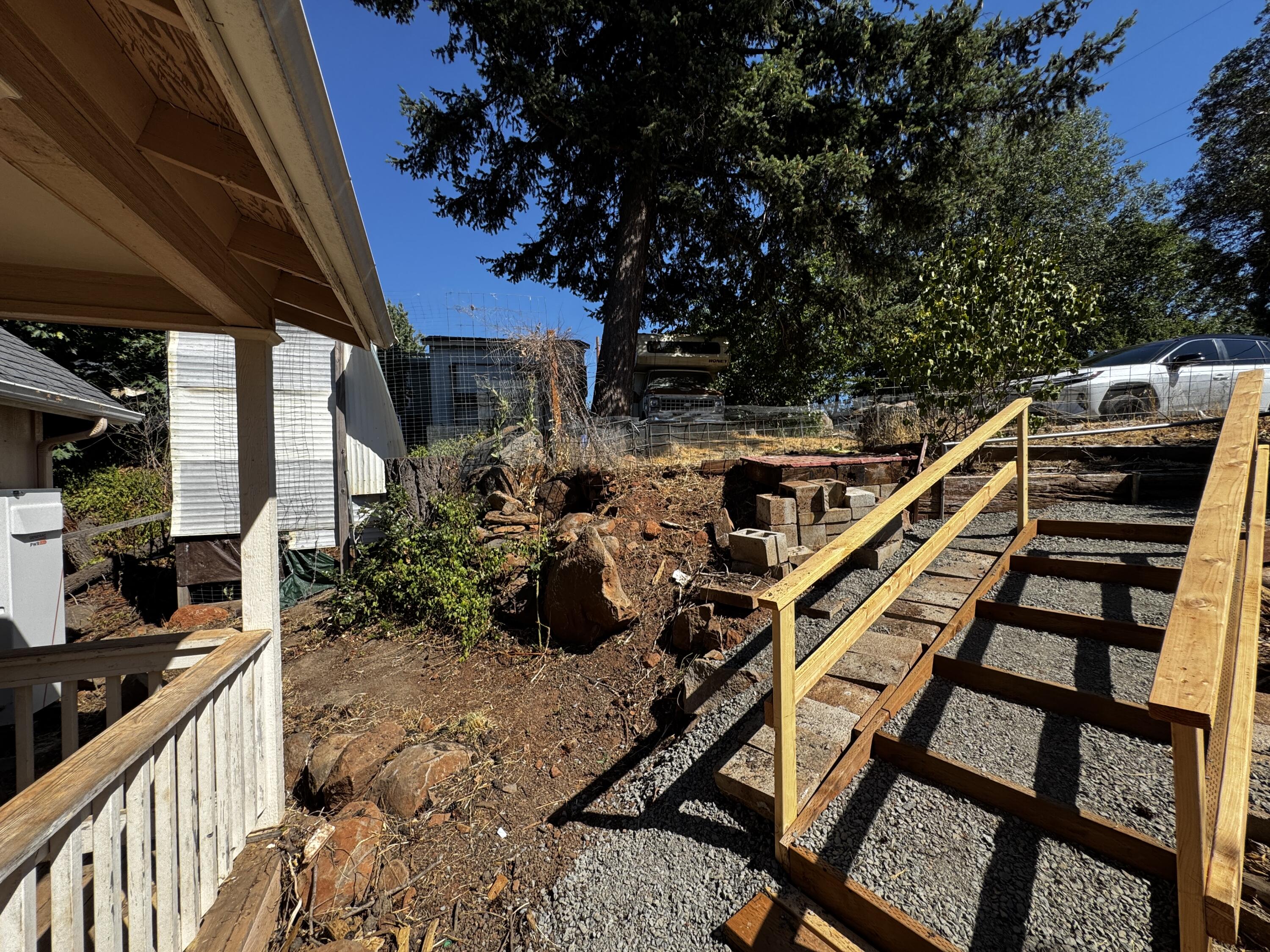 240 Bluff Street Butte Falls, OR 97522 - Photo 4 of 34 a view of a balcony with chairs and wooden fence