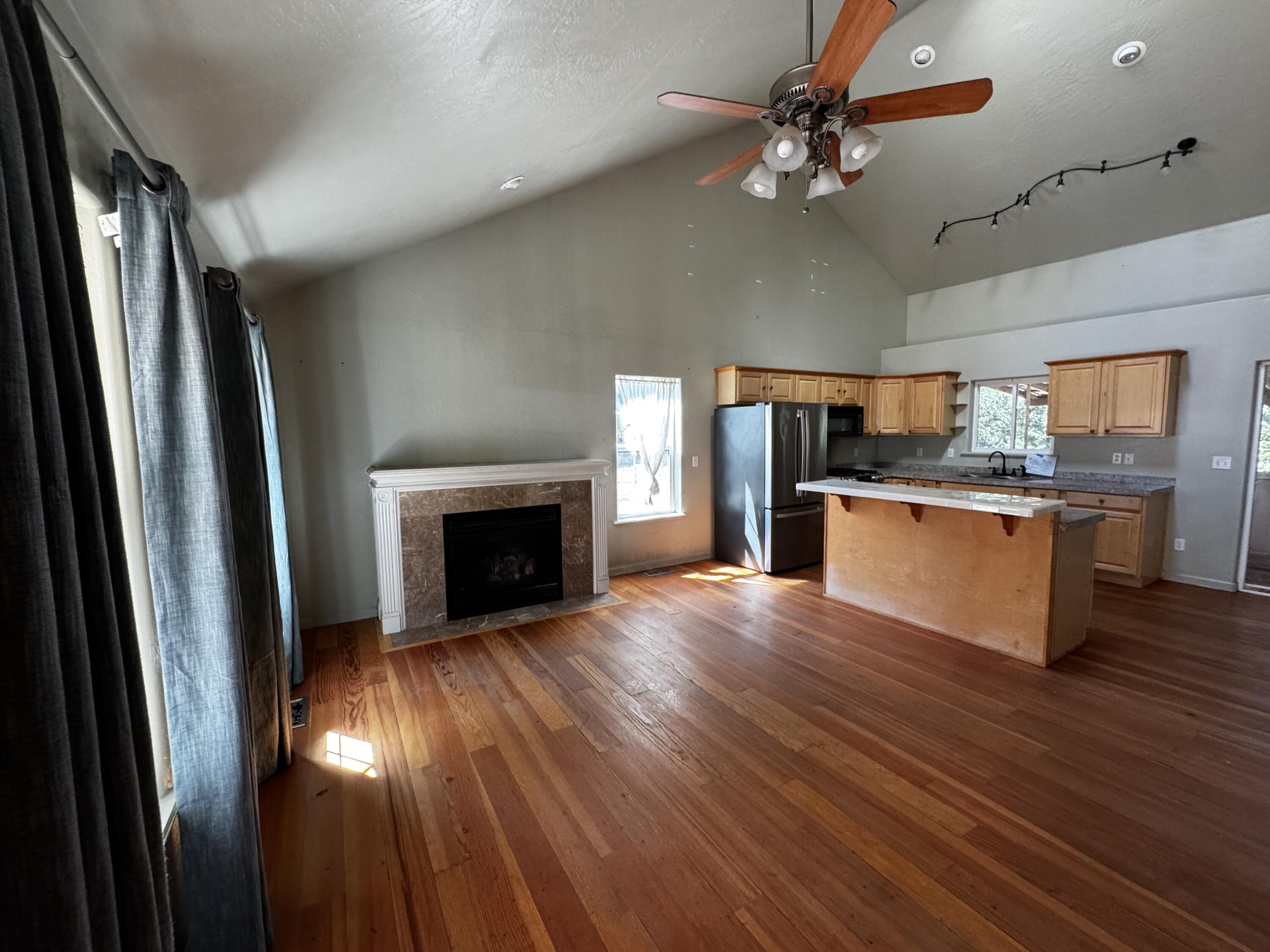 240 Bluff Street Butte Falls, OR 97522 - Photo 7 of 34 a view of kitchen with granite countertop stainless steel appliances and wooden floor