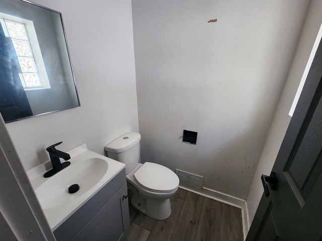 15441 East End Street Dolton, IL 60419 - Photo 14 of 16 a white toilet sitting next to a bathroom sink