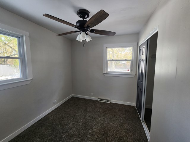 15441 East End Street Dolton, IL 60419 - Photo 10 of 16 an empty room with windows and fan