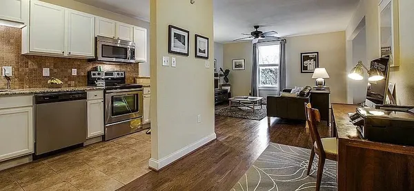 a kitchen with stainless steel appliances granite countertop a refrigerator stove top oven and sink