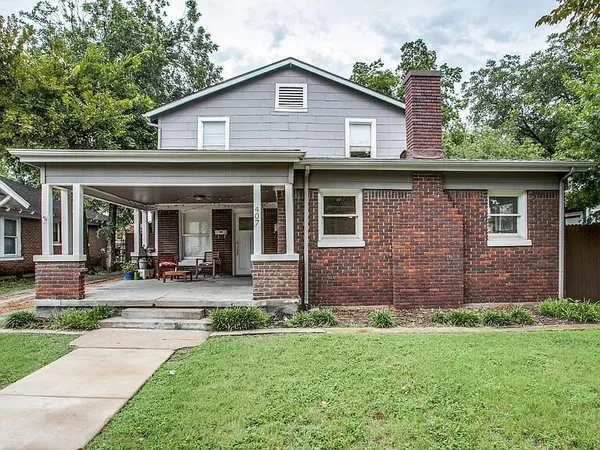 a front view of a house with garden and porch
