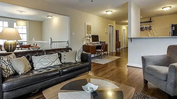 a living room with furniture and a lamp