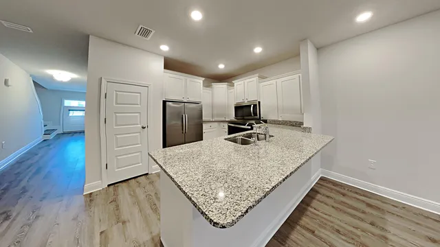 a kitchen with kitchen island sink refrigerator and stove