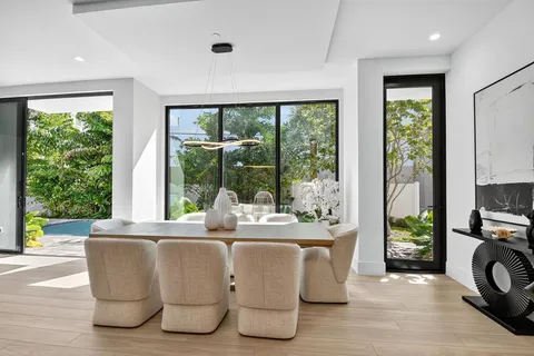 a dining room with furniture window and wooden floor