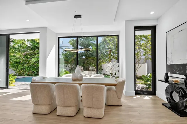 a dining room with furniture window and wooden floor