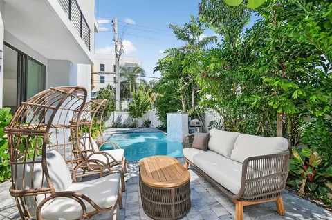 a bedroom with a bed and large windows