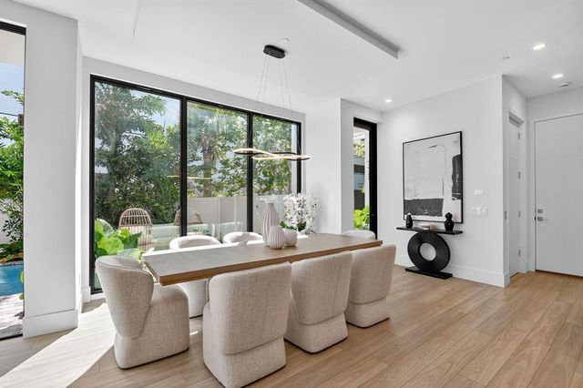 a bedroom with a large bed and a large window