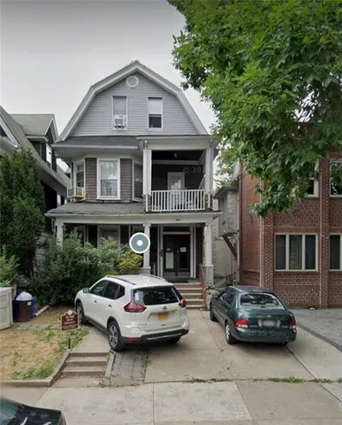 a car parked in front of a house