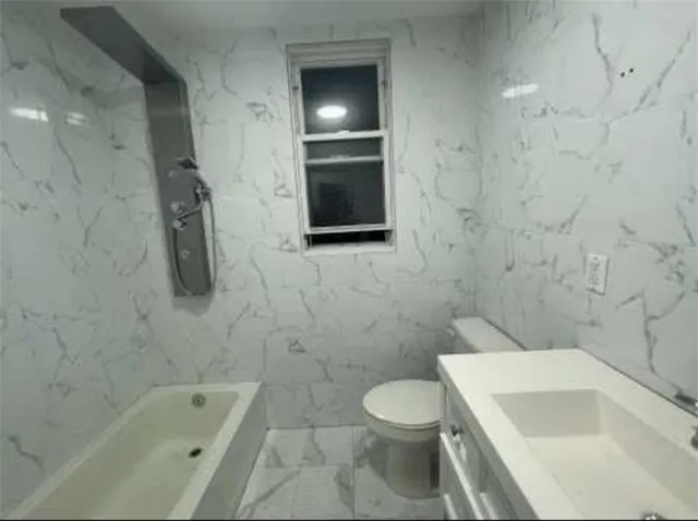 a bathroom with a sink a toilet and bathtub