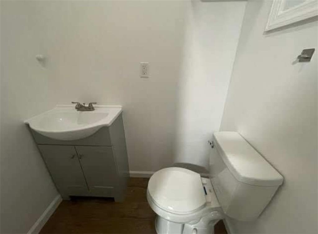 546 East 9th Street Brooklyn, NY 11218 - Photo 6 of 8 a bathroom with a sink a toilet and a mirror