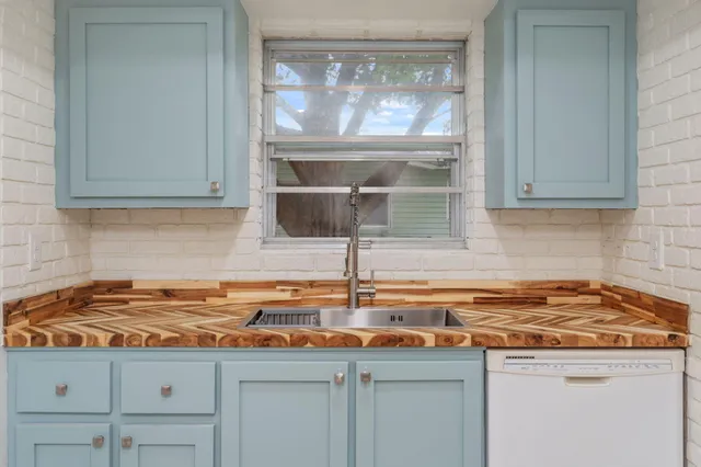 a kitchen with a sink and cabinets