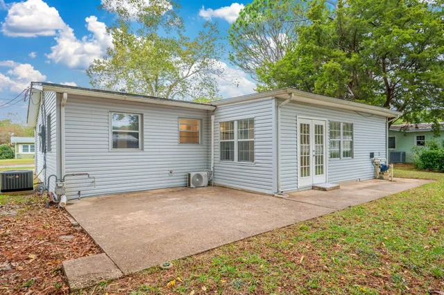 a view of a house with a yard and garage
