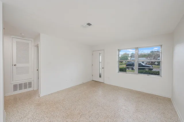 a view of an empty room with a window