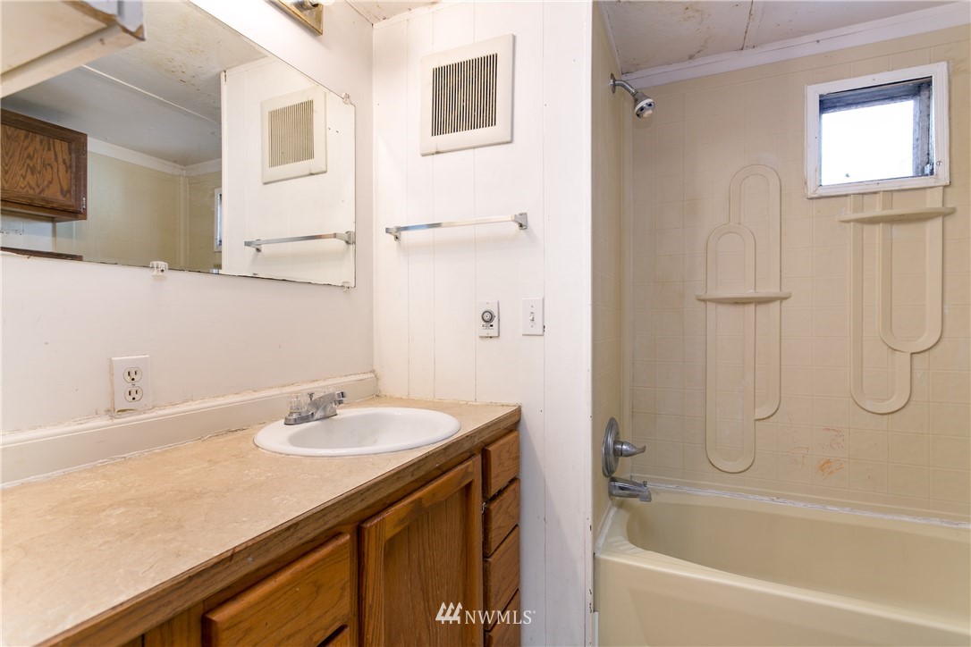 3676 North Red River Road Ferndale, WA 98248 - Photo 13 of 26 a bathroom with a granite countertop sink a mirror and a bathtub