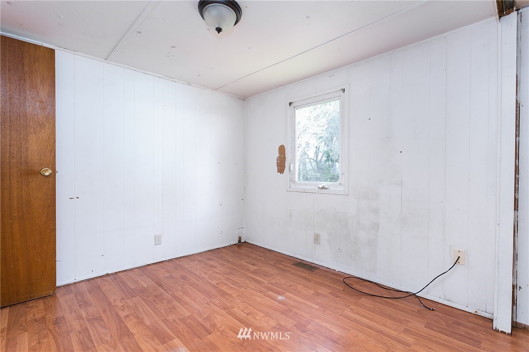 3676 North Red River Road Ferndale, WA 98248 - Photo 17 of 26 an empty room with wooden floor and windows