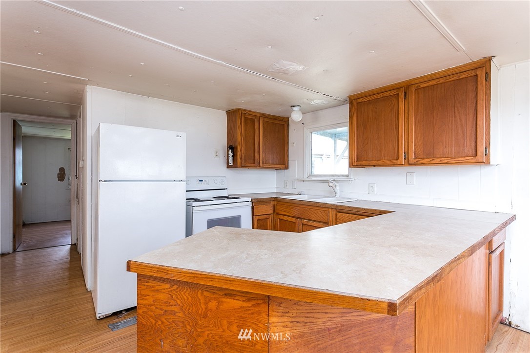 3676 North Red River Road Ferndale, WA 98248 - Photo 9 of 26 a kitchen with stainless steel appliances granite countertop a sink a refrigerator and a stove top oven