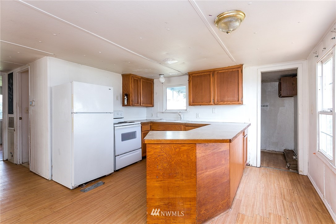 3676 North Red River Road Ferndale, WA 98248 - Photo 10 of 26 a kitchen with stainless steel appliances granite countertop a refrigerator a stove a sink and a microwave