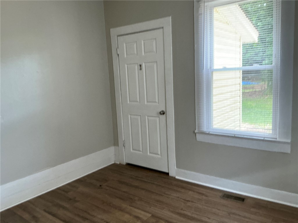 504 Caughlin Avenue Anderson, SC 29624 - Photo 9 of 15 A window-lit room features durable wood flooring and ample wall space.