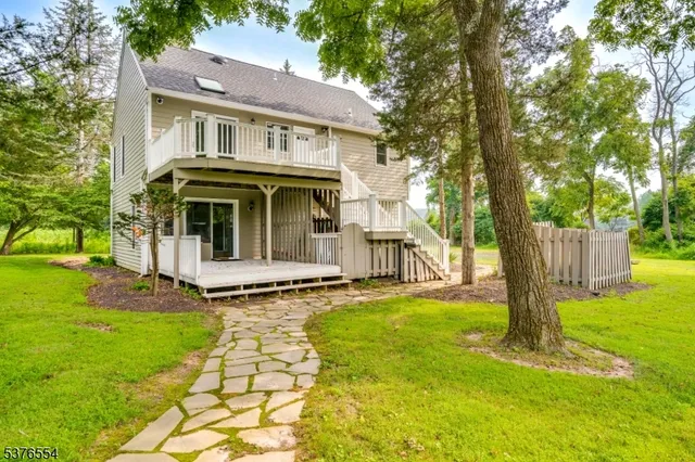 a view of a house with a yard and a house
