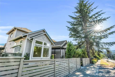 a view of a house with a small yard and plants