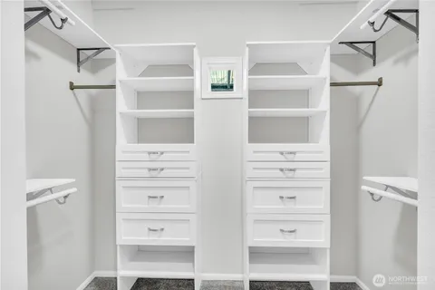 a view of walk in closet with empty racks