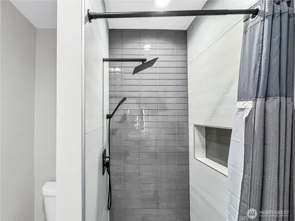 a bathroom with a shower and a mirror