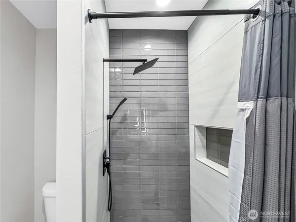 a bathroom with a shower and a mirror