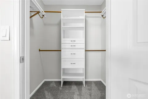 a view of walk in closet with empty racks