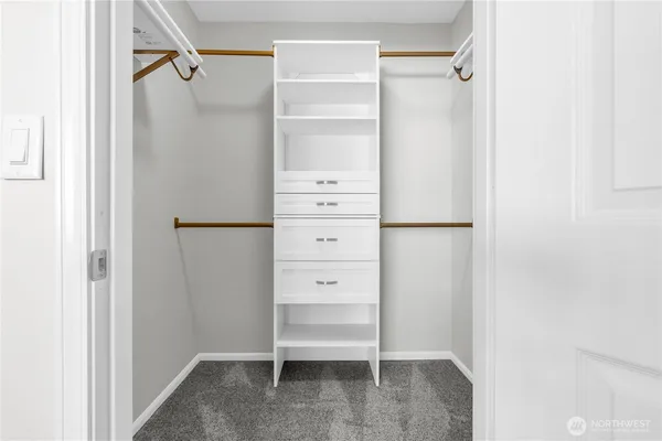 a view of walk in closet with empty racks