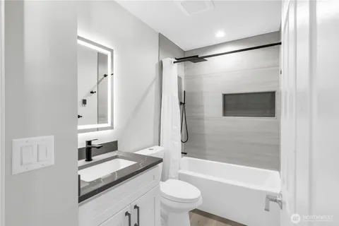 a bathroom with a sink a toilet and a bathtub