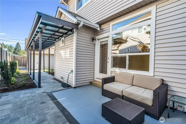 a balcony with furniture and a potted plant