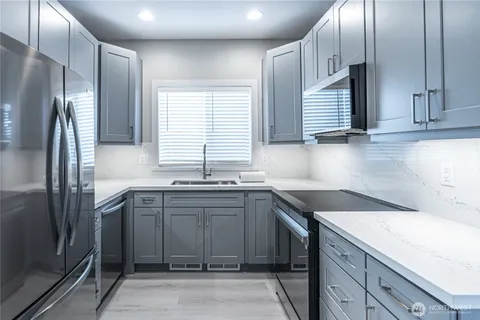 a kitchen with a sink stove and refrigerator