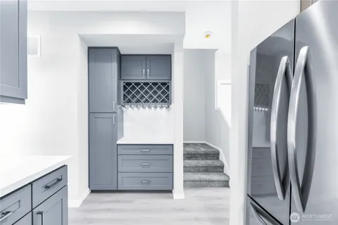 a walk in closet with white cabinets