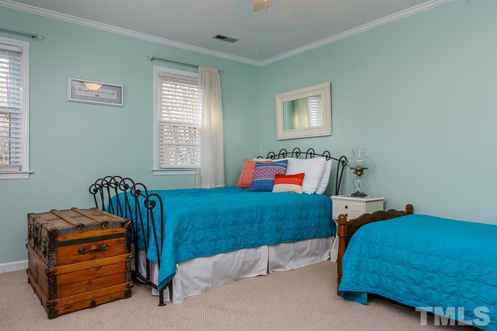 6932 Three Bridges Circle Raleigh, NC 27613 - Photo 16 of 25 a bedroom with two beds and a window
