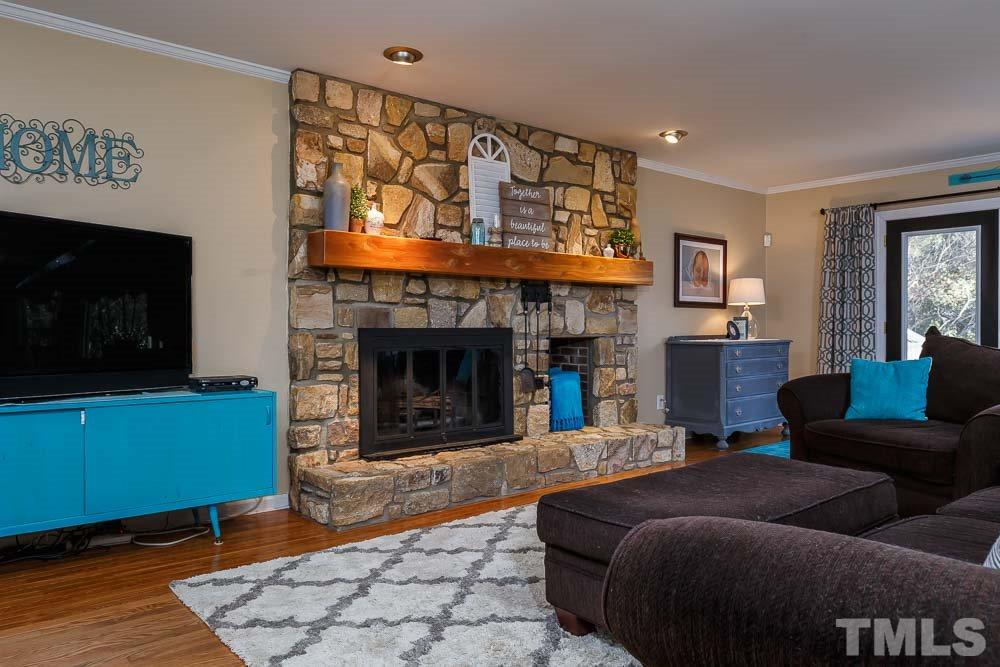 6932 Three Bridges Circle Raleigh, NC 27613 - Photo 4 of 25 a living room with furniture and a fireplace