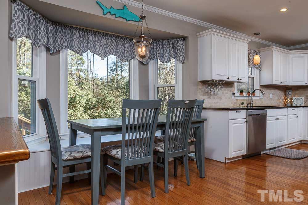 6932 Three Bridges Circle Raleigh, NC 27613 - Photo 6 of 25 a dining room with furniture and wooden floor