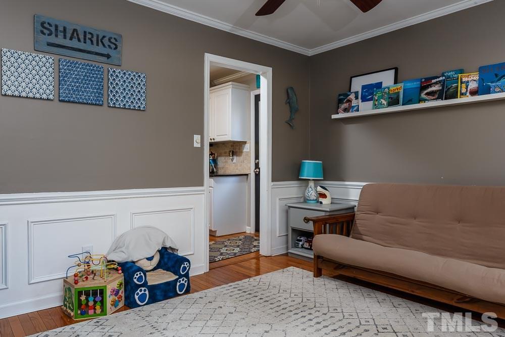 6932 Three Bridges Circle Raleigh, NC 27613 - Photo 10 of 25 a living room with furniture and a shelf