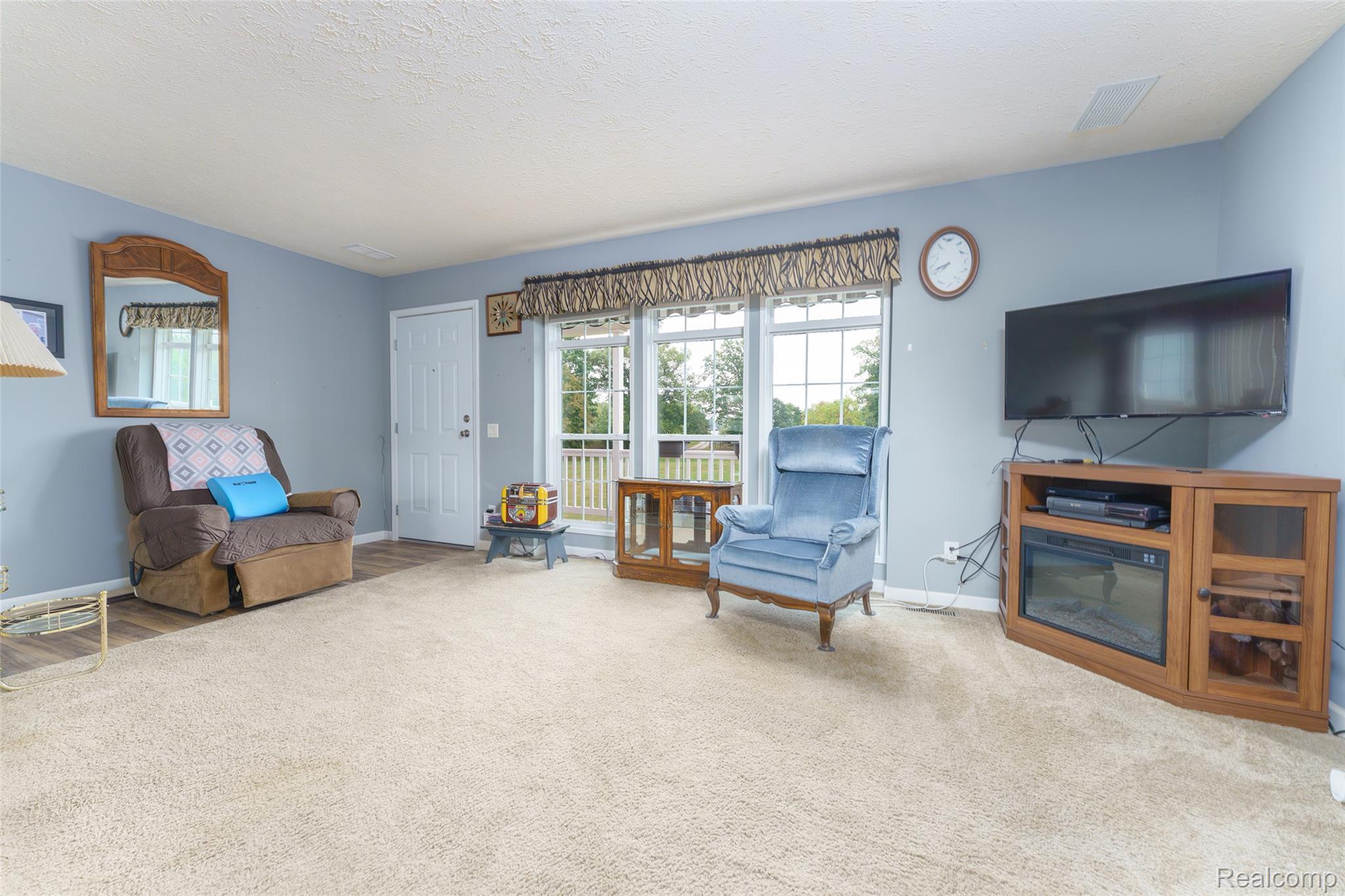 5601 West Lovejoy Road Byron, MI 48418 - Photo 2 of 40 Living area with a textured ceiling and carpet floors