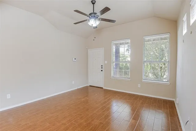 wooden floor in an empty room with a window