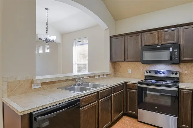 a kitchen with a sink stove and microwave