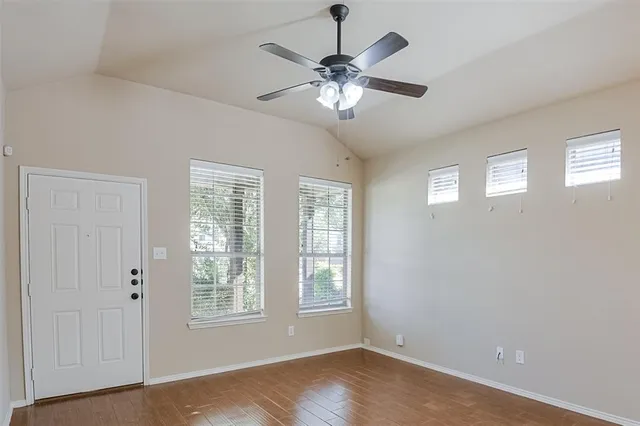 wooden floor in an empty room with a window